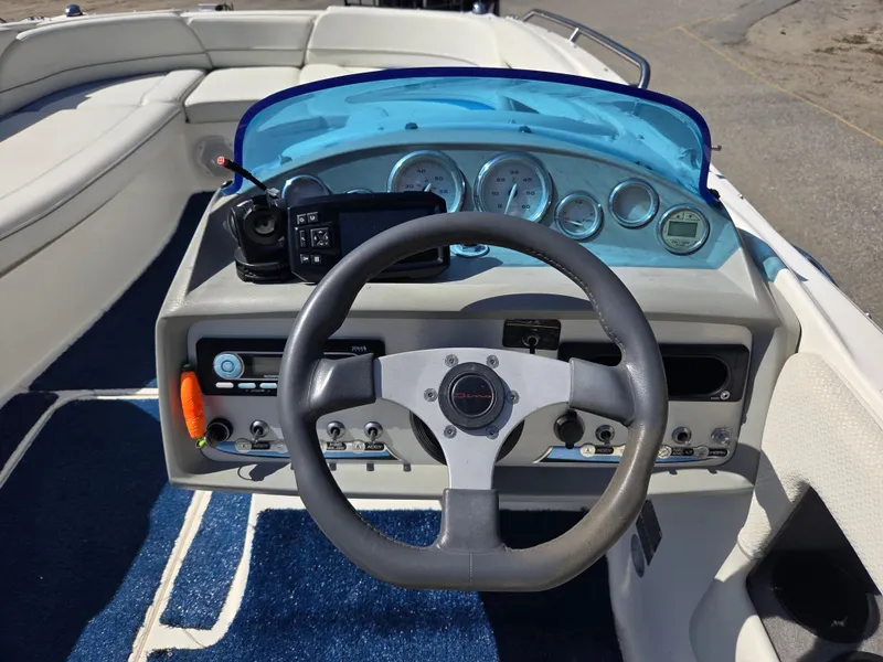 Slide: The Image of 2007 Bayliner 217 Deck Boat dashboard with steering wheel and instrument panel. - 16