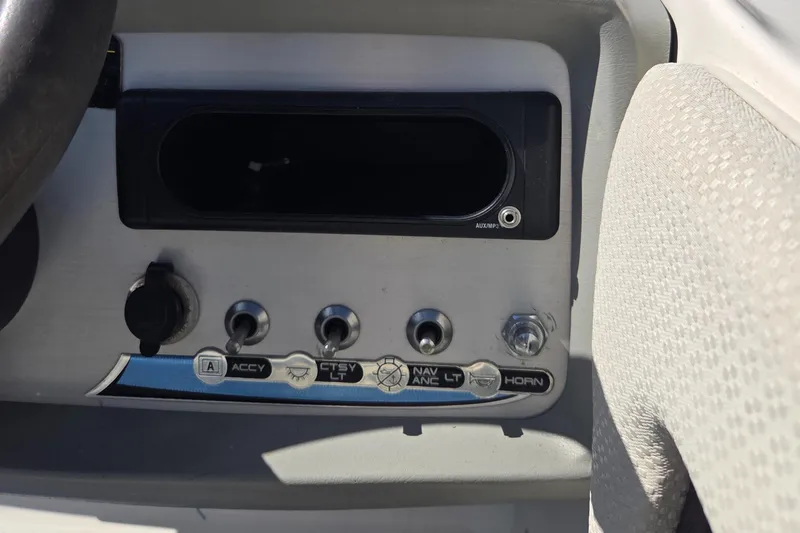 Slide: The Image of Control panel of a 2007 Bayliner 217 Deck Boat with switches and controls. - 18