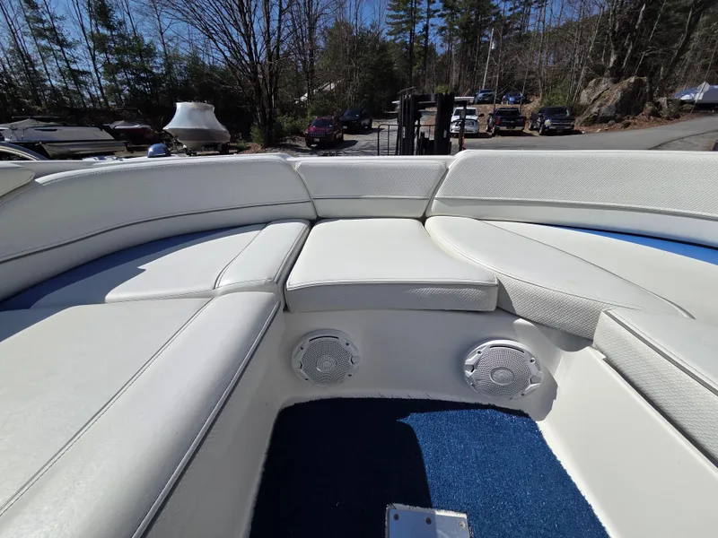 Slide: The Image of 2007 Bayliner 217 Deck Boat interior with white seating and blue carpet. - 21