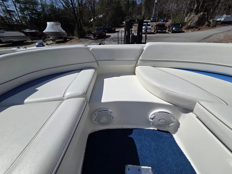 Slide: The Image of 2007 Bayliner 217 Deck Boat interior with white seating and blue carpet. - 22