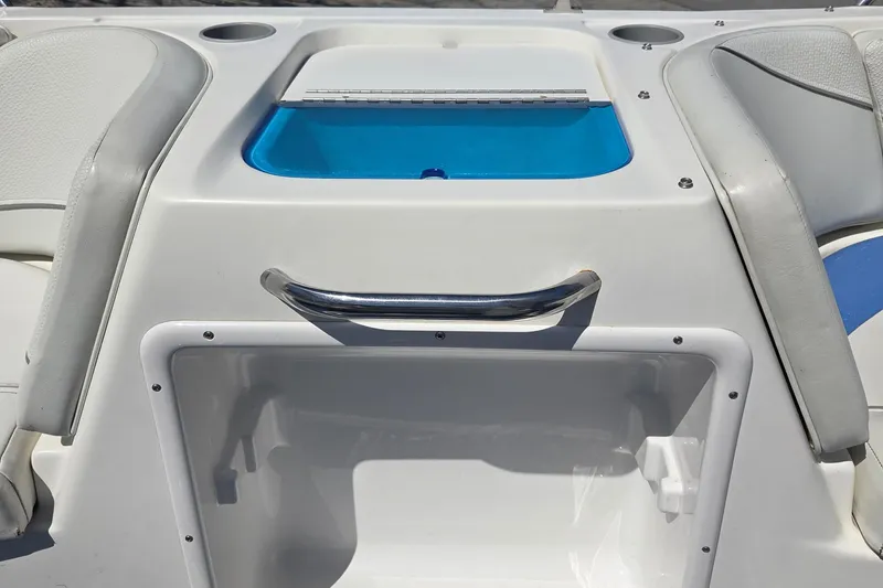 Slide: The Image of 2007 Bayliner 217 Deck Boat interior with storage compartment and seating. - 23