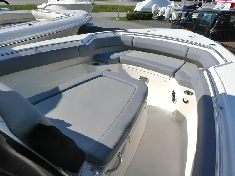 Slide: The Image of 2025 Boston Whaler 280 Outrage boat interior with cushioned seating and spacious deck area. - 11