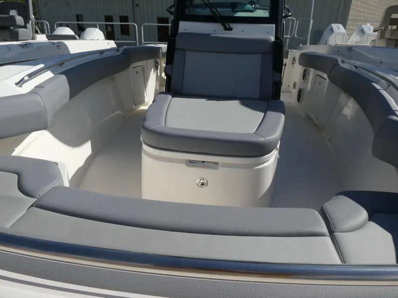 Slide: The Image of 2025 Boston Whaler 280 Outrage boat interior with gray seating and spacious layout. - 14