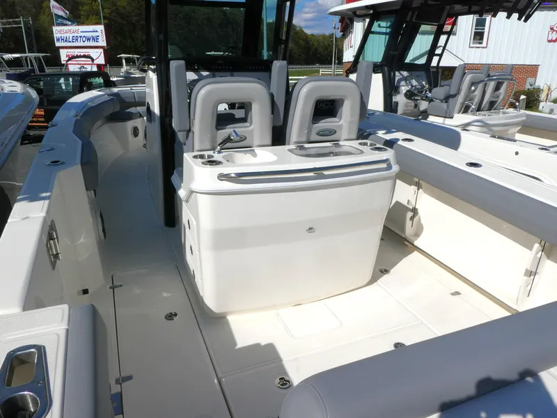 Slide: The Image of 2025 Boston Whaler 280 Outrage boat interior with seating and console, showcasing modern design. - 2