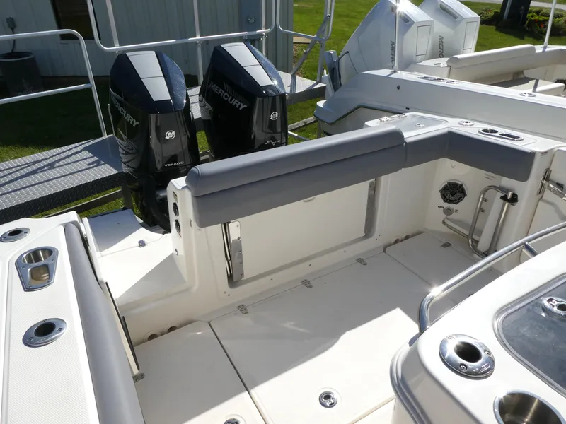 Slide: The Image of 2025 Boston Whaler 280 Outrage boat interior with dual Mercury engines and seating area. - 4