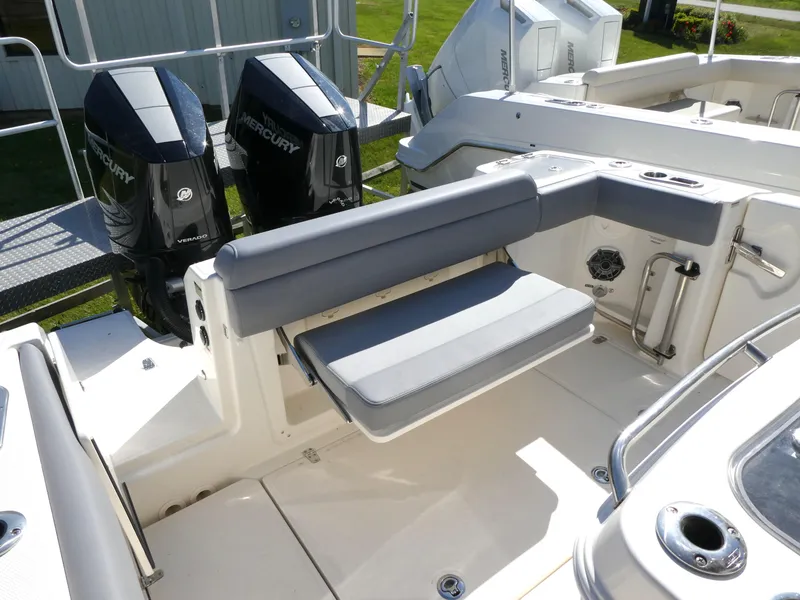 Slide: The Image of 2025 Boston Whaler 280 Outrage boat interior with seating and dual Mercury engines. - 5