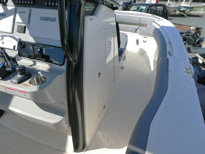 Slide: The Image of 2025 Boston Whaler 280 Outrage boat interior with Simrad electronics and sleek design. - 8