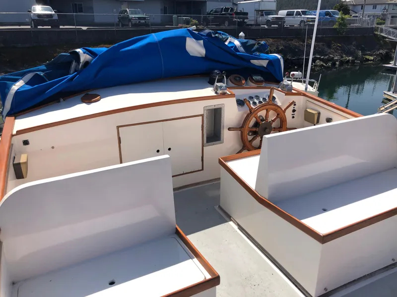 Slide: The Image of 1976 Grand Banks 42 Classic boat deck with wooden trim and blue tarp covering. - 14