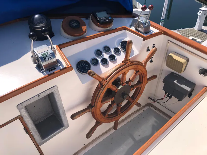 Slide: The Image of 1976 Grand Banks 42 Classic helm with wooden wheel and navigation instruments. - 15