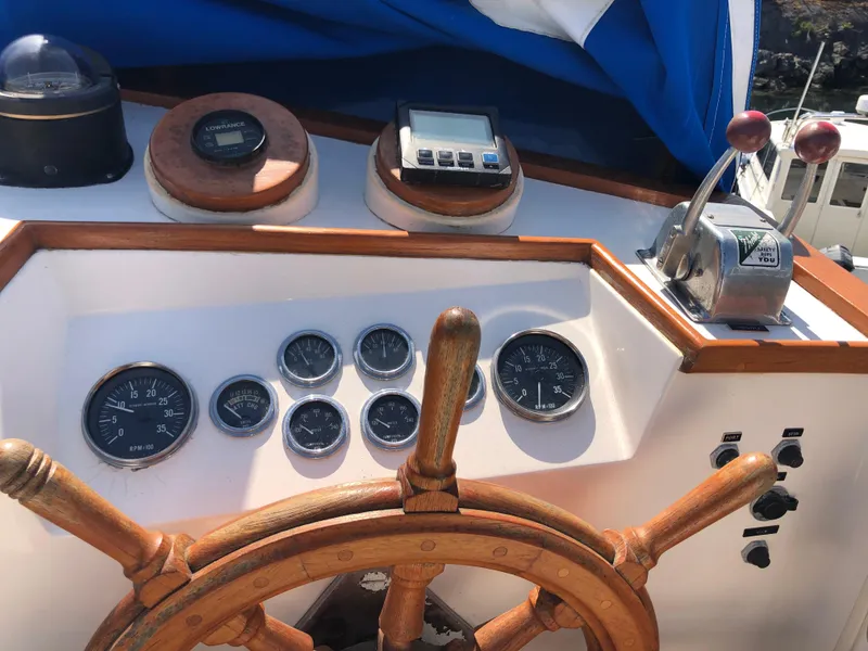 Slide: The Image of Helm of 1976 Grand Banks 42 Classic with wooden wheel and navigation instruments. - 17