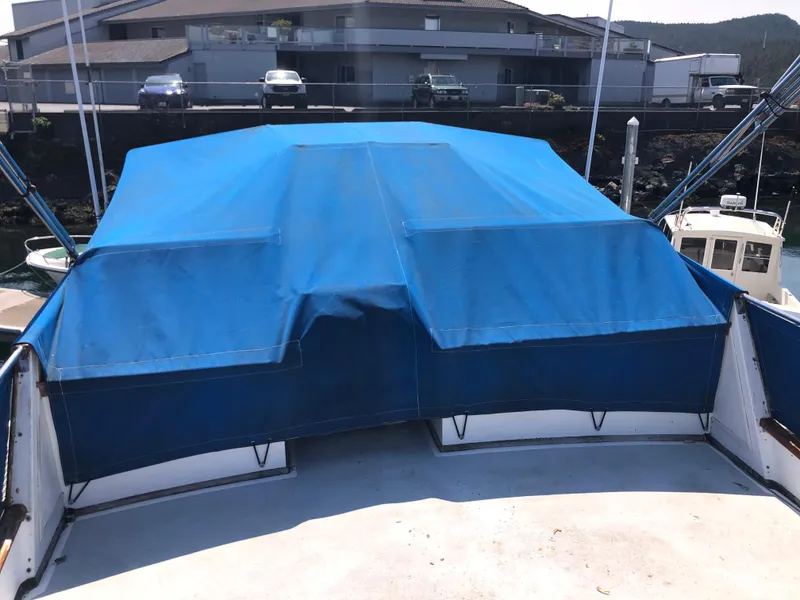 Slide: The Image of 1976 Grand Banks 42 Classic boat with blue canvas cover at dock. - 19