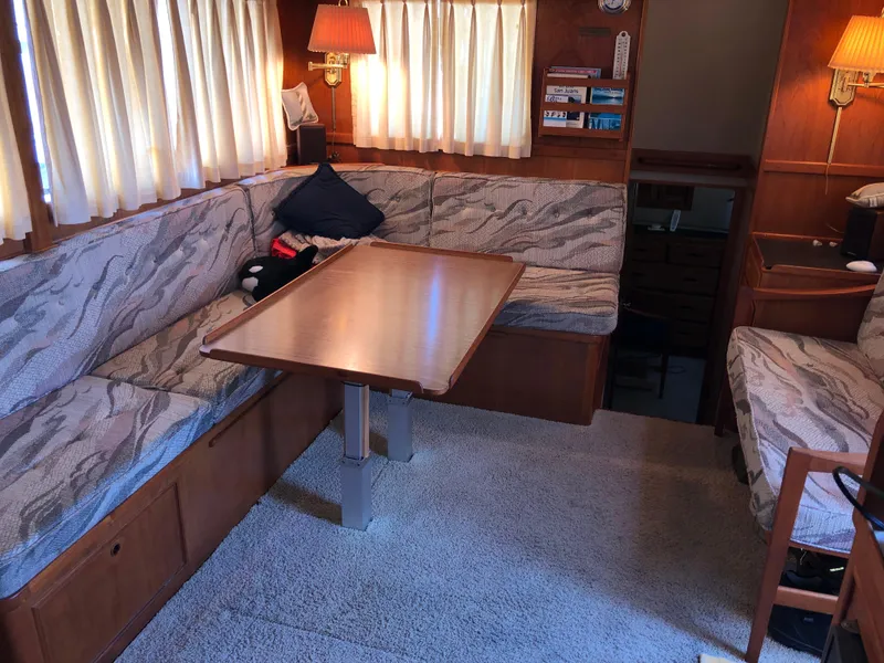 Slide: The Image of Interior of a 1976 Grand Banks 42 Classic yacht with cozy seating and wooden table. - 23