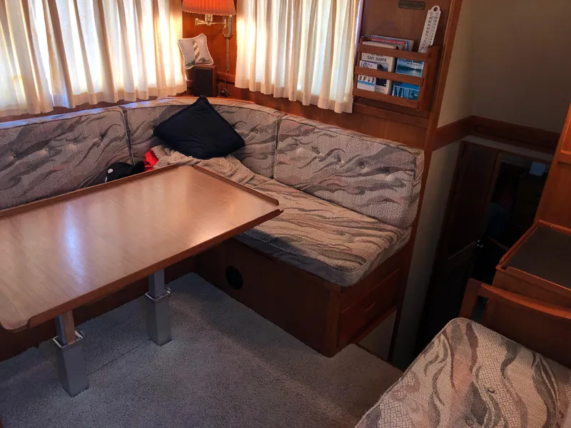 Slide: The Image of 1976 Grand Banks 42 Classic interior with cozy seating and wooden table. - 24