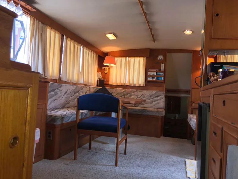 Slide: The Image of Interior of a 1976 Grand Banks 42 Classic boat with cozy seating and wooden cabinetry. - 26