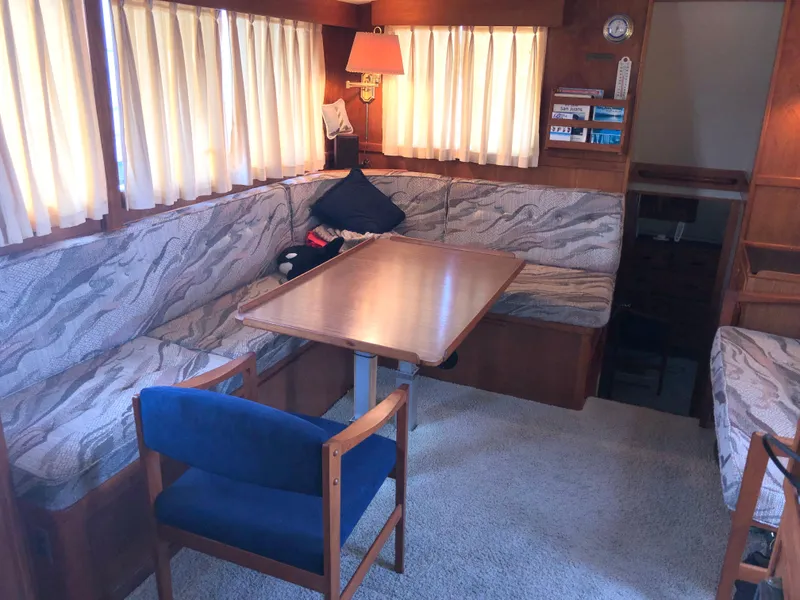 Slide: The Image of 1976 Grand Banks 42 Classic interior with cozy seating, wooden table, and nautical decor. - 27