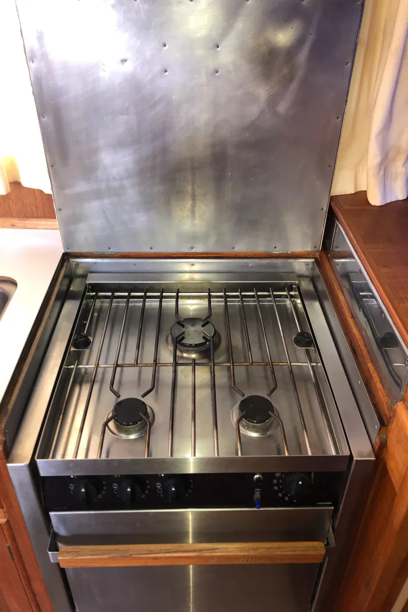Slide: The Image of 1976 Grand Banks 42 Classic yacht kitchen with stainless steel stove and oven. - 30