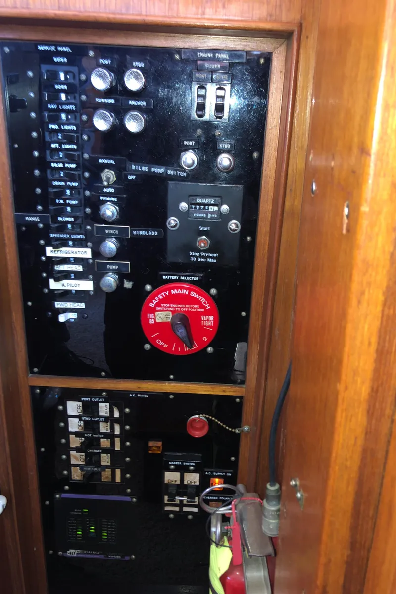 Slide: The Image of Electrical panel of a 1976 Grand Banks 42 Classic boat, featuring switches and controls. - 37