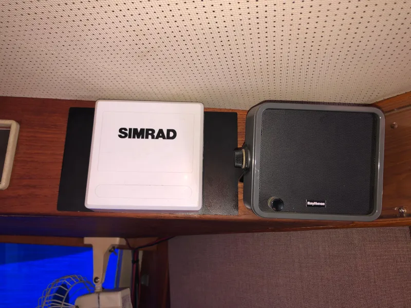 Slide: The Image of Simrad device and speaker on 1976 Grand Banks 42 Classic boat interior. - 39