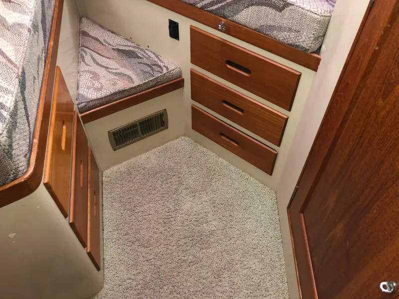 Slide: The Image of Interior of 1976 Grand Banks 42 Classic with wooden drawers and patterned cushions. - 44