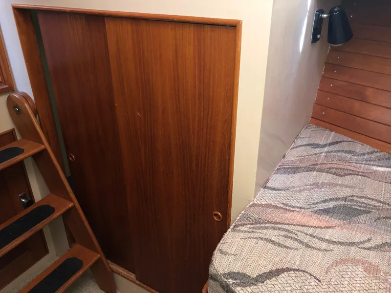 Slide: The Image of Interior of 1976 Grand Banks 42 Classic with wooden paneling and patterned bedding. - 45