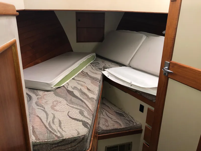 Slide: The Image of 1976 Grand Banks 42 Classic cabin interior with cushioned sleeping area. - 46