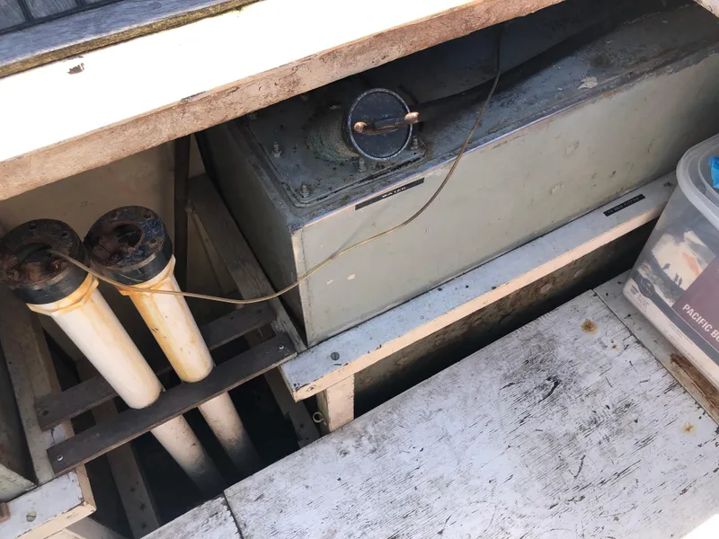 Slide: The Image of 1976 Grand Banks 42 Classic engine compartment with mechanical components and storage area. - 8