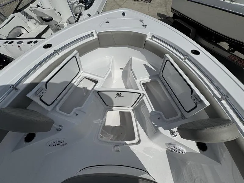 Slide: The Image of 2025 Sportsman Open 212 boat interior with open storage compartments and seating. - 10