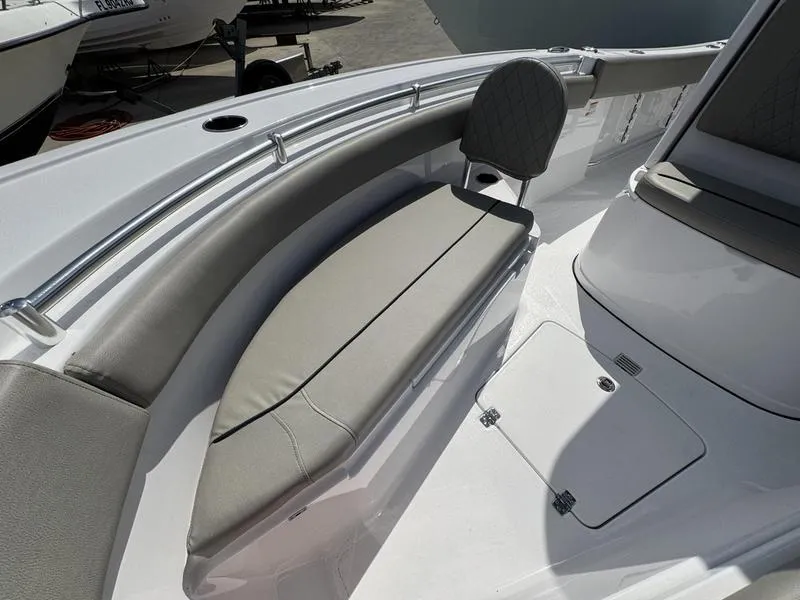 Slide: The Image of 2025 Sportsman Open 212 boat interior with cushioned seating and storage compartment. - 11