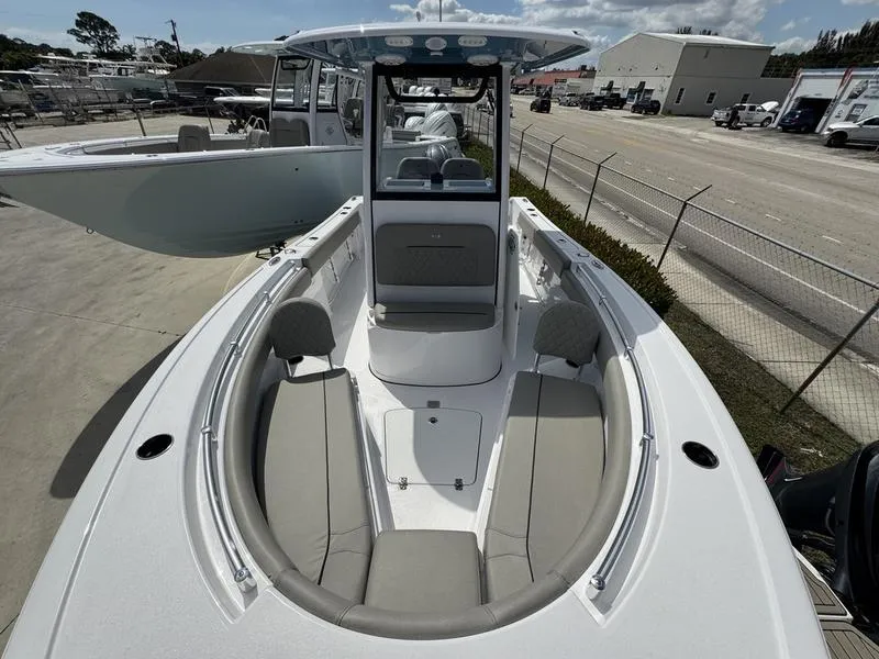 Slide: The Image of 2025 Sportsman Open 212 boat with spacious seating and modern design at a marina. - 13