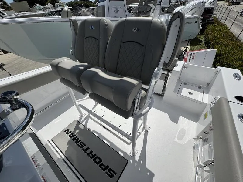 Slide: The Image of 2025 Sportsman Open 212 boat with dual cushioned seats and steering console. - 20
