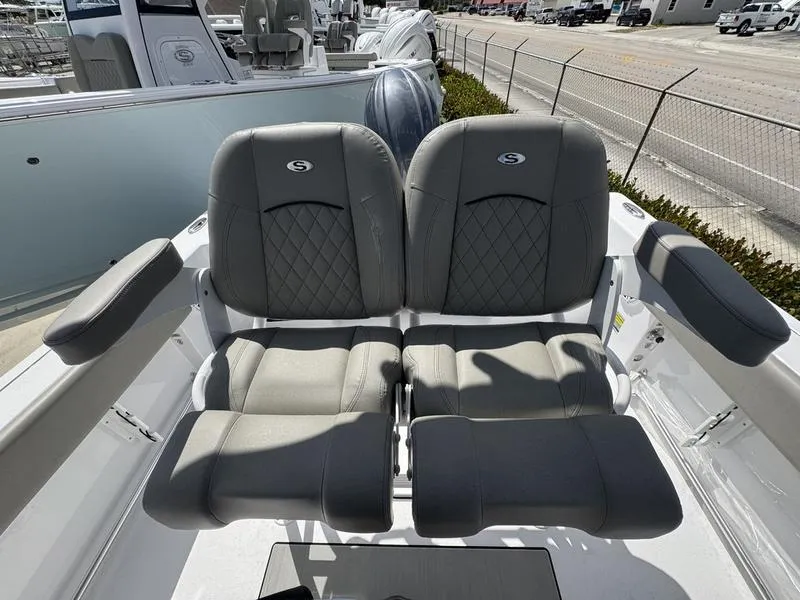 Slide: The Image of 2025 Sportsman Open 212 boat seats, gray leather, diamond stitching, outdoor setting. - 21