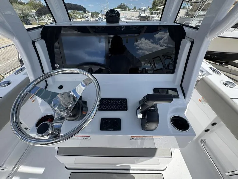 Slide: The Image of 2025 Sportsman Open 212 boat dashboard with steering wheel and controls. - 23