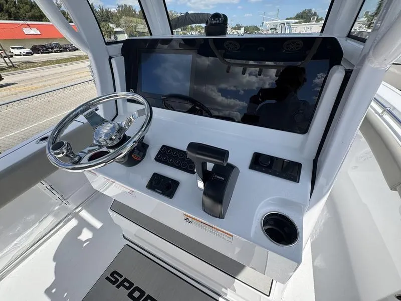 Slide: The Image of 2025 Sportsman Open 212 boat dashboard with steering wheel and controls. - 24