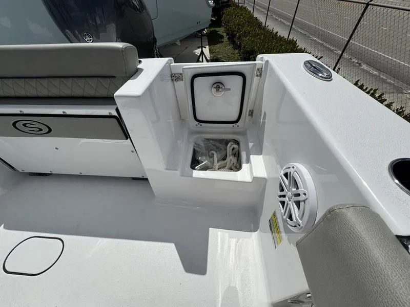 Slide: The Image of 2025 Sportsman Open 212 boat interior with storage compartment and speaker. - 29