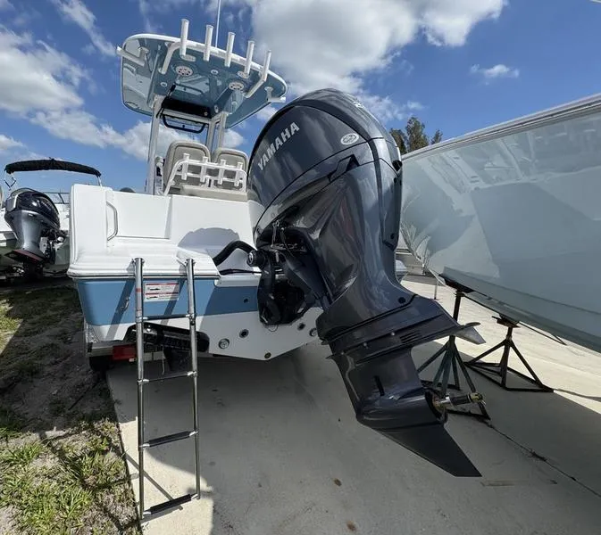 Slide: The Image of 2025 Sportsman Open 212 boat with Yamaha outboard motor, docked under a blue sky. - 3