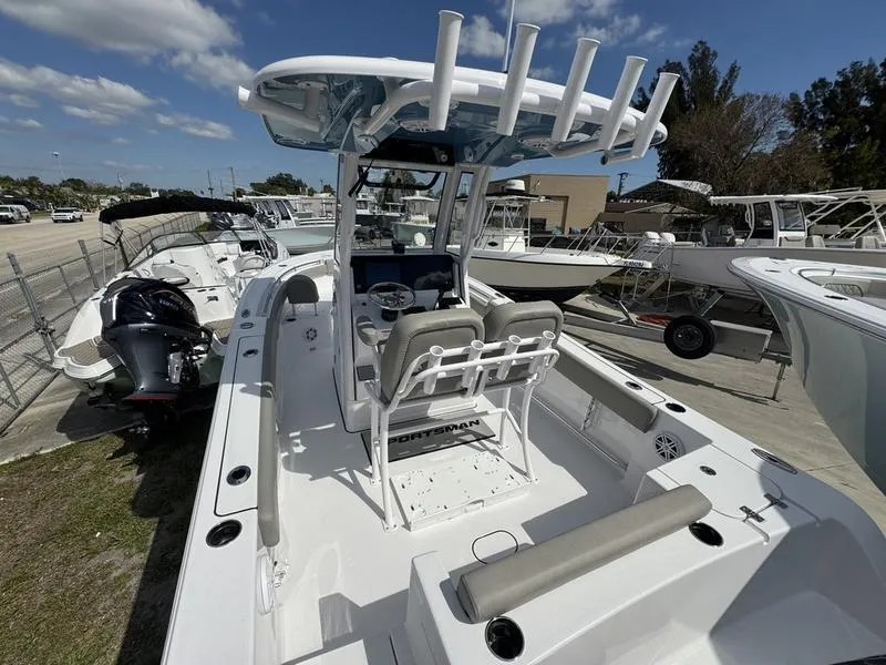 Slide: The Image of 2025 Sportsman Open 212 boat with center console, docked under a clear blue sky. - 4