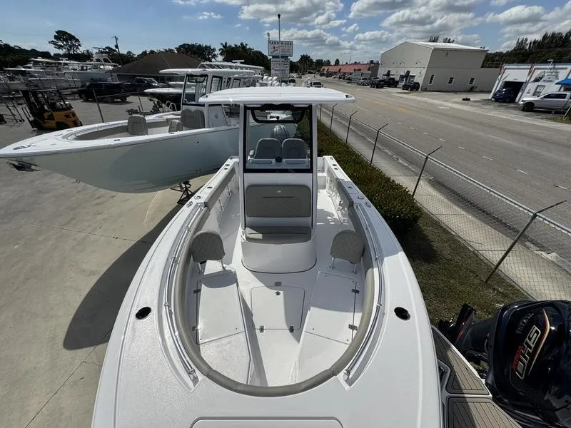 Slide: The Image of 2025 Sportsman Open 212 boat, docked, with clear skies and industrial background. - 7