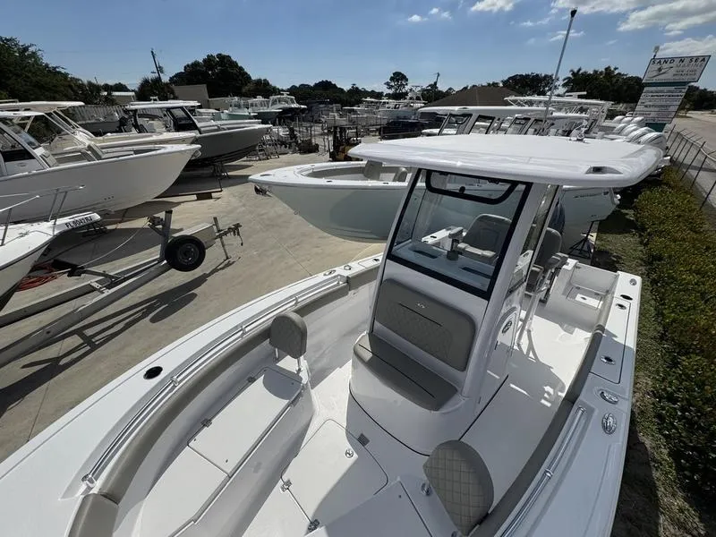 Slide: The Image of 2025 Sportsman Open 212 boat displayed in a marina with other boats. - 9