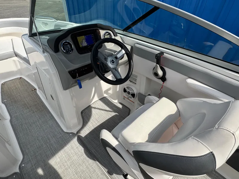 Slide: The Image of 2019 Chaparral 21 H2O Sport OB boat interior with steering wheel and seating. - 13