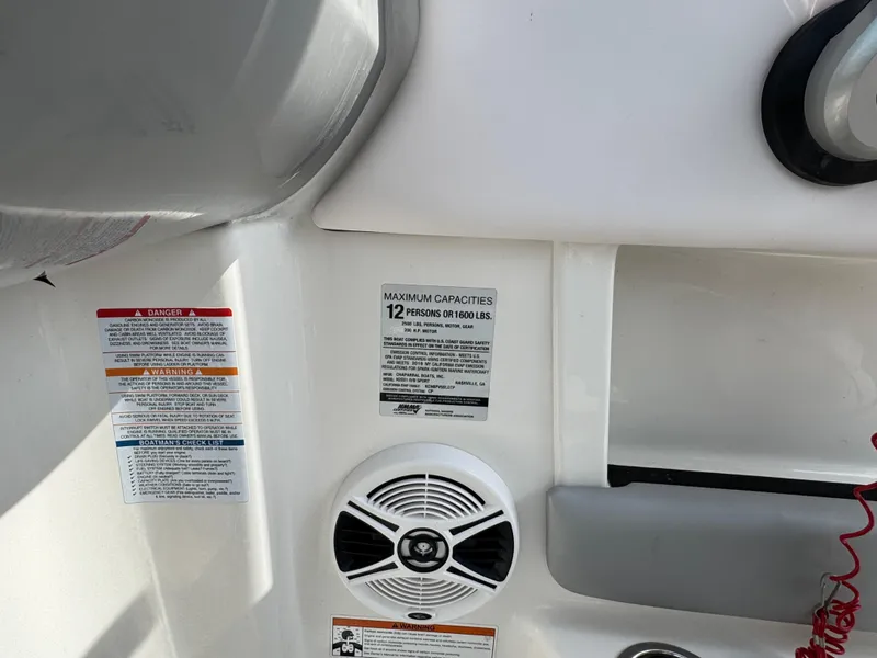 Slide: The Image of 2019 Chaparral 21 H2O Sport OB interior with capacity and safety labels. - 15