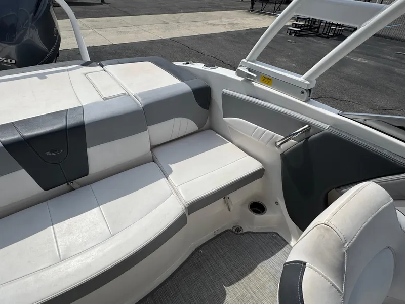 Slide: The Image of 2019 Chaparral 21 H2O Sport OB boat interior with white and gray seating. - 18