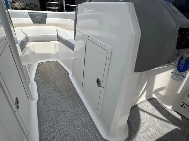 Slide: The Image of 2019 Chaparral 21 H2O Sport OB boat interior with seating and storage compartment. - 21