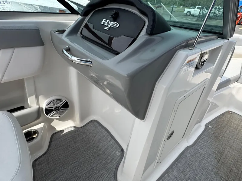 Slide: The Image of 2019 Chaparral 21 H2O Sport OB interior dashboard with sleek design and speaker. - 23