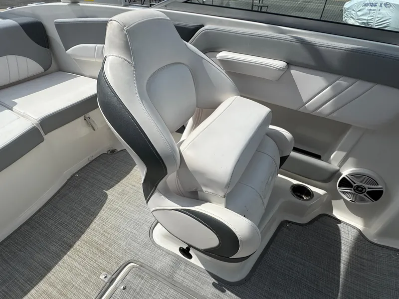 Slide: The Image of 2019 Chaparral 21 H2O Sport OB boat interior with cushioned seating and speaker. - 25