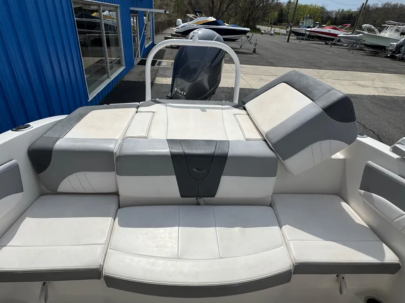 Slide: The Image of 2019 Chaparral 21 H2O Sport OB boat with cushioned seating and sleek design. - 28