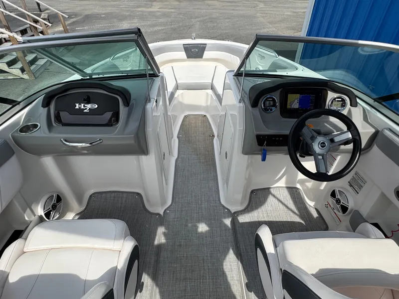 Slide: The Image of 2019 Chaparral 21 H2O Sport OB boat interior with steering wheel and seating. - 31