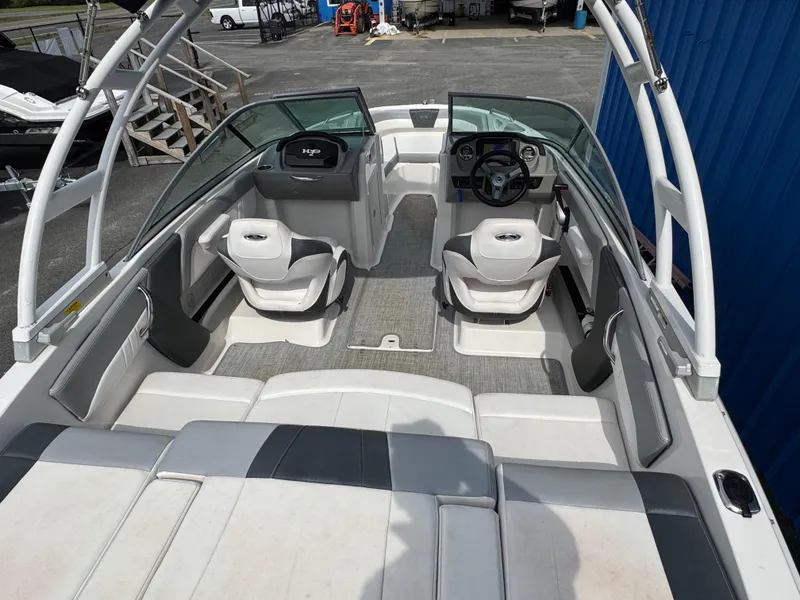 Slide: The Image of 2019 Chaparral 21 H2O Sport OB boat interior with seating and steering wheel. - 33