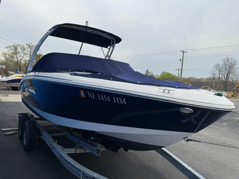 Slide: The Image of 2019 Chaparral 21 H2O Sport OB boat on trailer, covered, parked outdoors. - 5