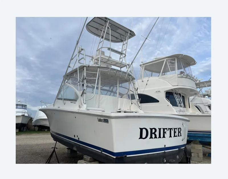 Slide: The Image of 2007 Luhrs 28 Open boat named "Drifter" on dry dock, side view. - 3