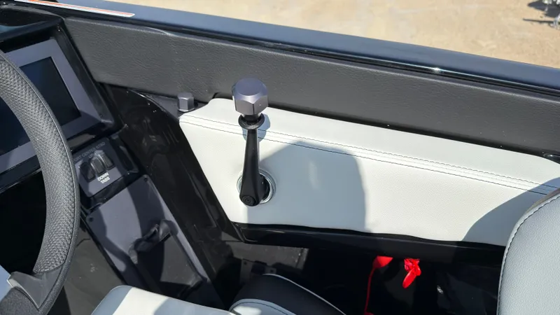 Slide: The Image of Interior of 2025 MasterCraft NXT20 with throttle lever and dashboard. - 27